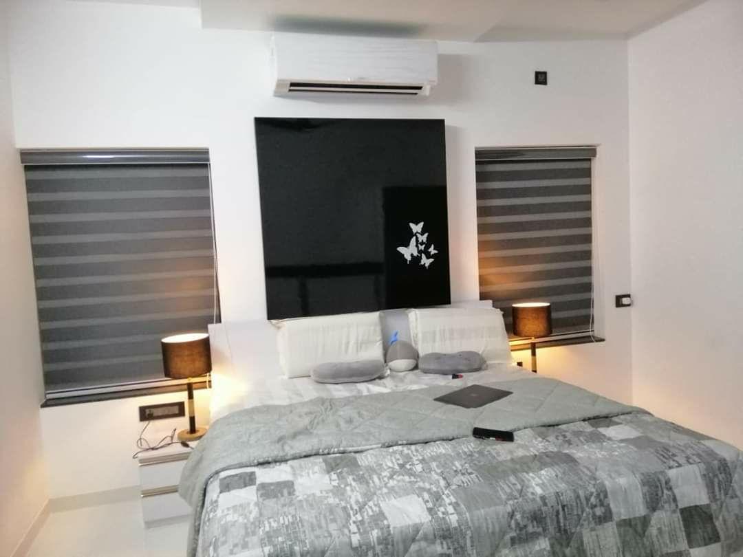 Contemporary bedroom with modern grey striped zebra blinds installation by M.A Blinds & Curtains