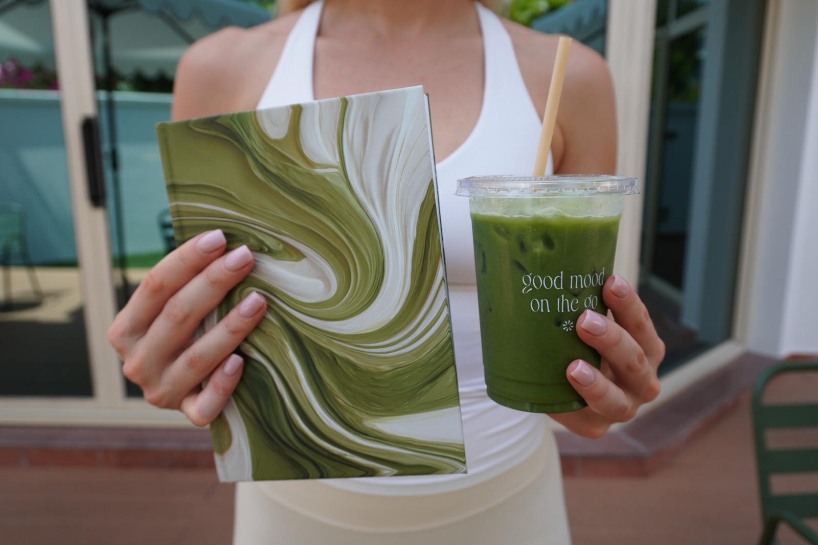 Green marble journal held next to a matcha drink