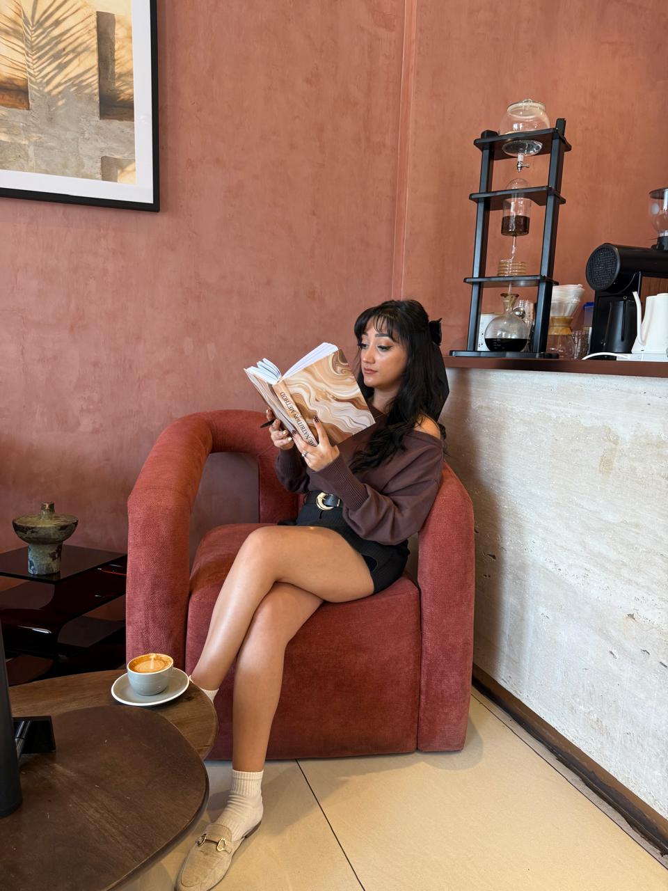 Natasha reading the Natrition Method journal in a cafe