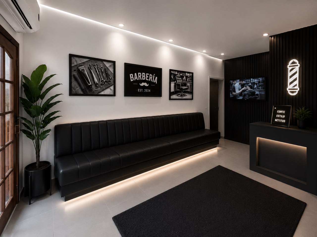 Sala de espera de Gian Barber — sillón de cuero, TV y zona de recepción