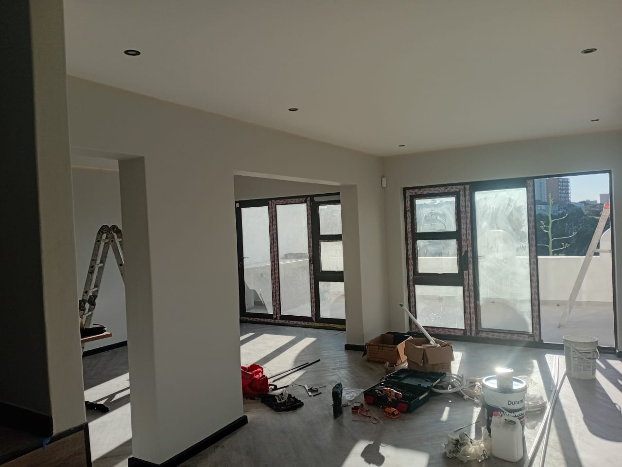 Interior painting Port Elizabeth — kitchen area with white painted ceiling, recessed downlights, charcoal grey cabinetry with open shelving