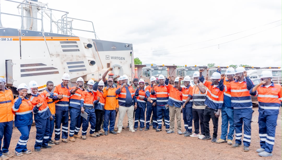 Full GHLEM workforce gathered with mining equipment and transport trucks