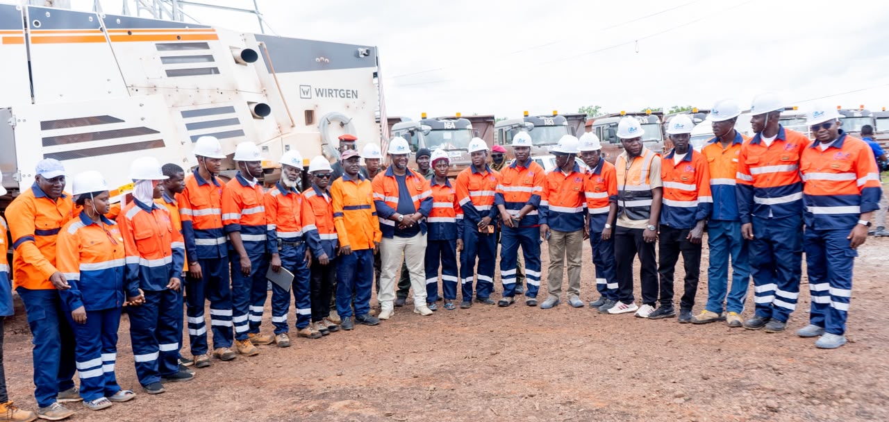 GHLEM team assembled beside mining equipment and transport fleet