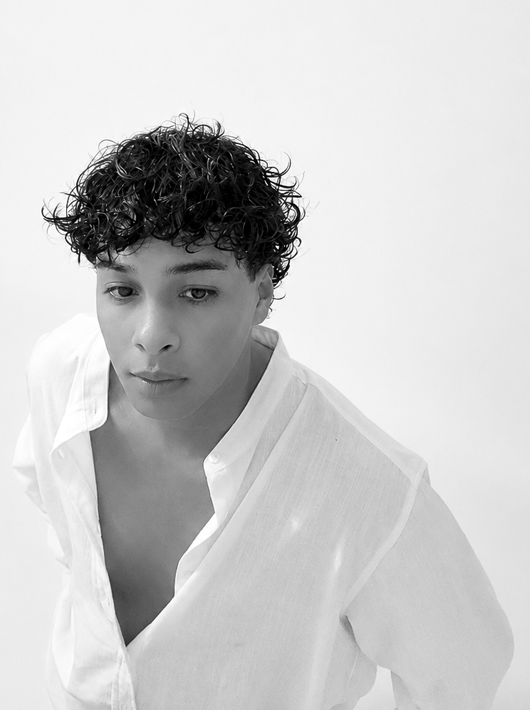 Black-and-white portrait of a person in a white shirt