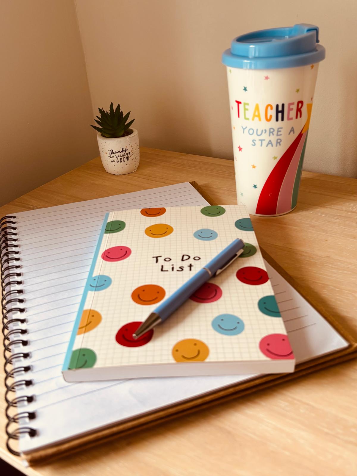 A notebook, pen and cheerful stationery prepared for learning