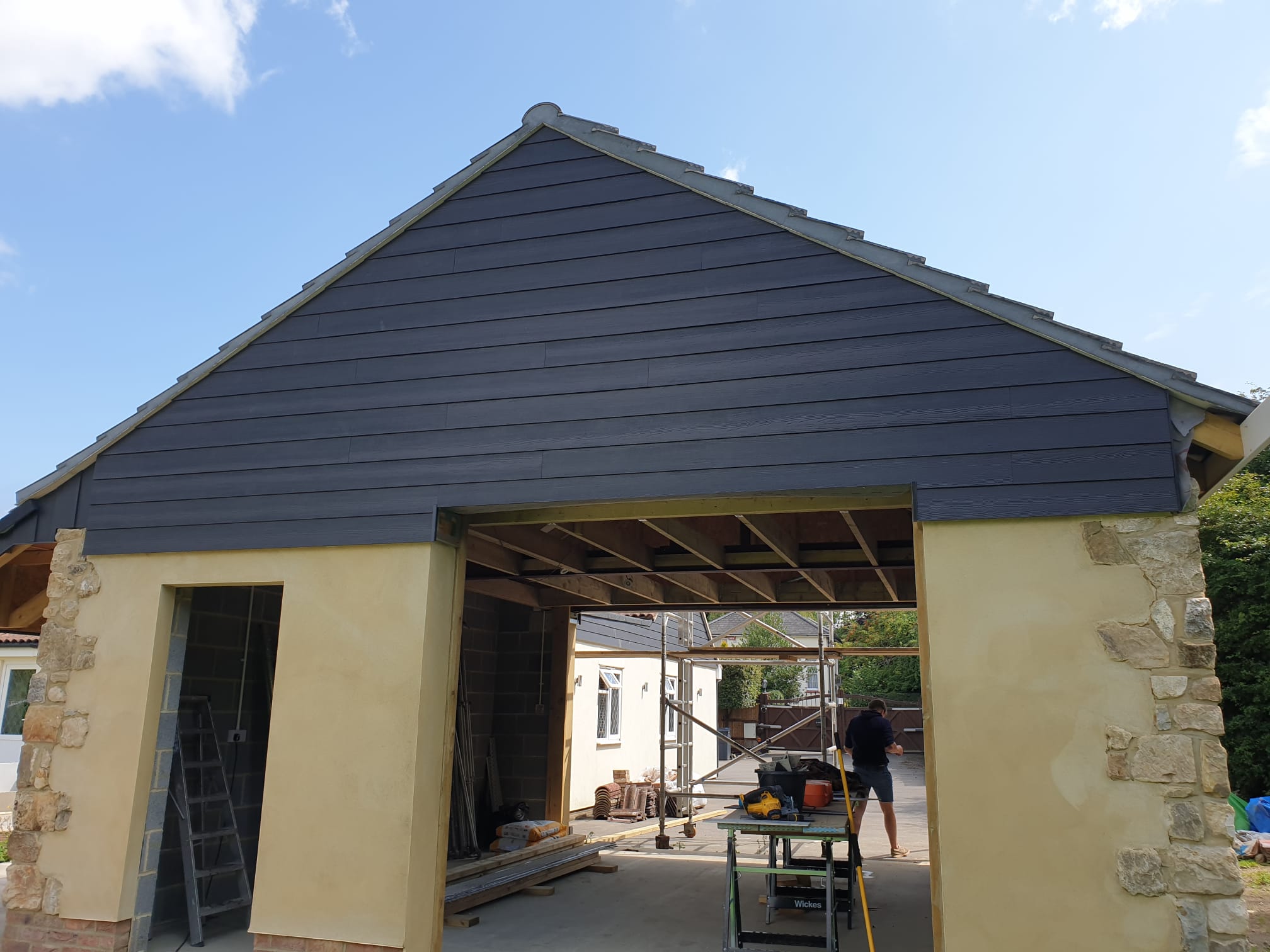 Detail of composite cladding and precise brickwork on a Mountain River Ltd build