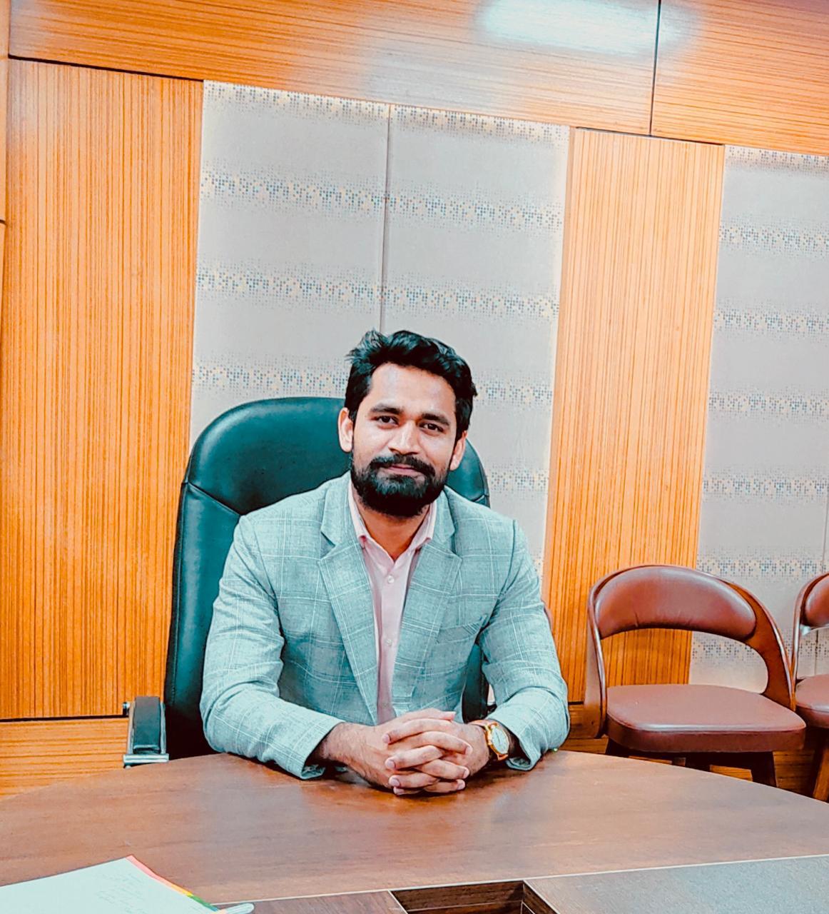 Morshed Al Tasfiq Bin Zakir seated in a light grey blazer in an office