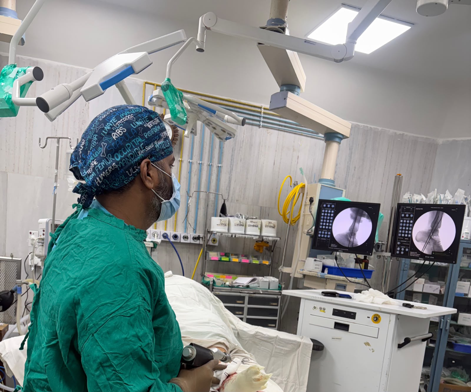 Dr. Sunil performing an image-guided orthopedic procedure in the operating theatre