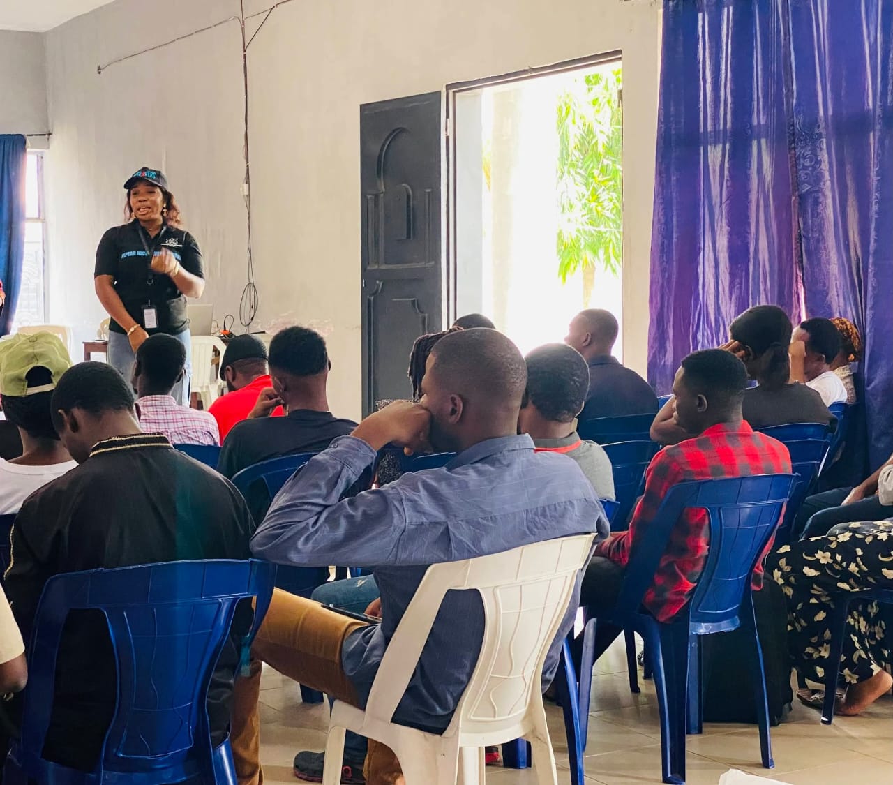 NICERIVERS facilitator presenting to a seated community training session in Rivers State