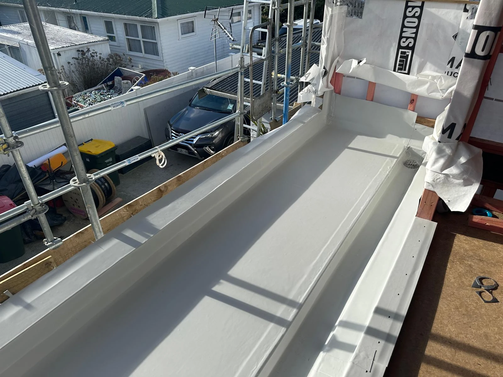 White membrane roof detail around a home extension