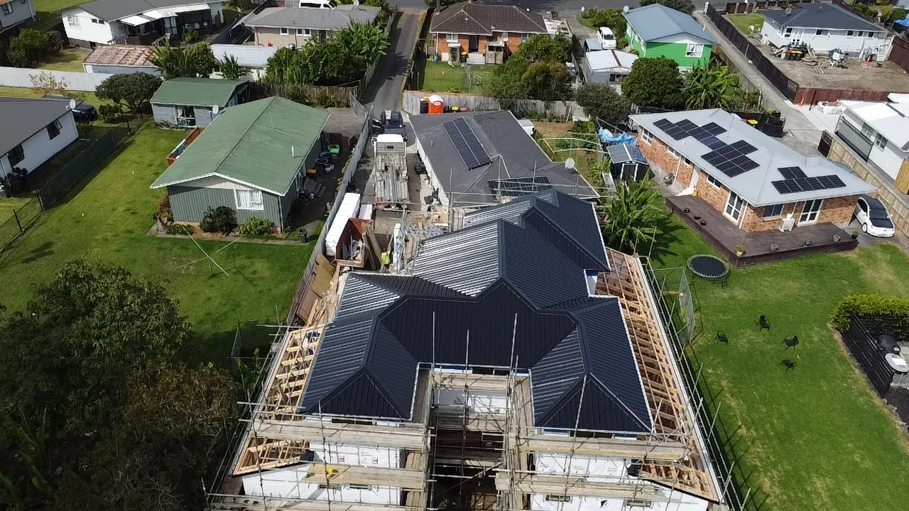 Aerial view of a new dark metal roof installation