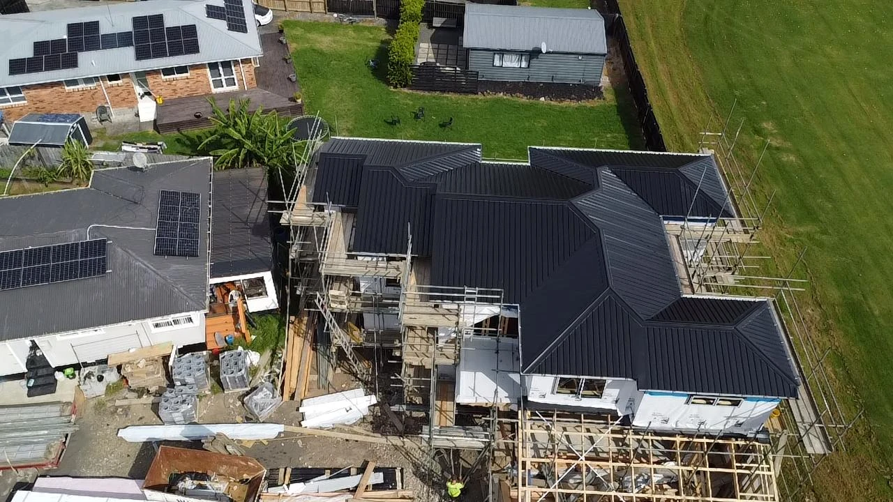 Aerial view of complex dark roof sections