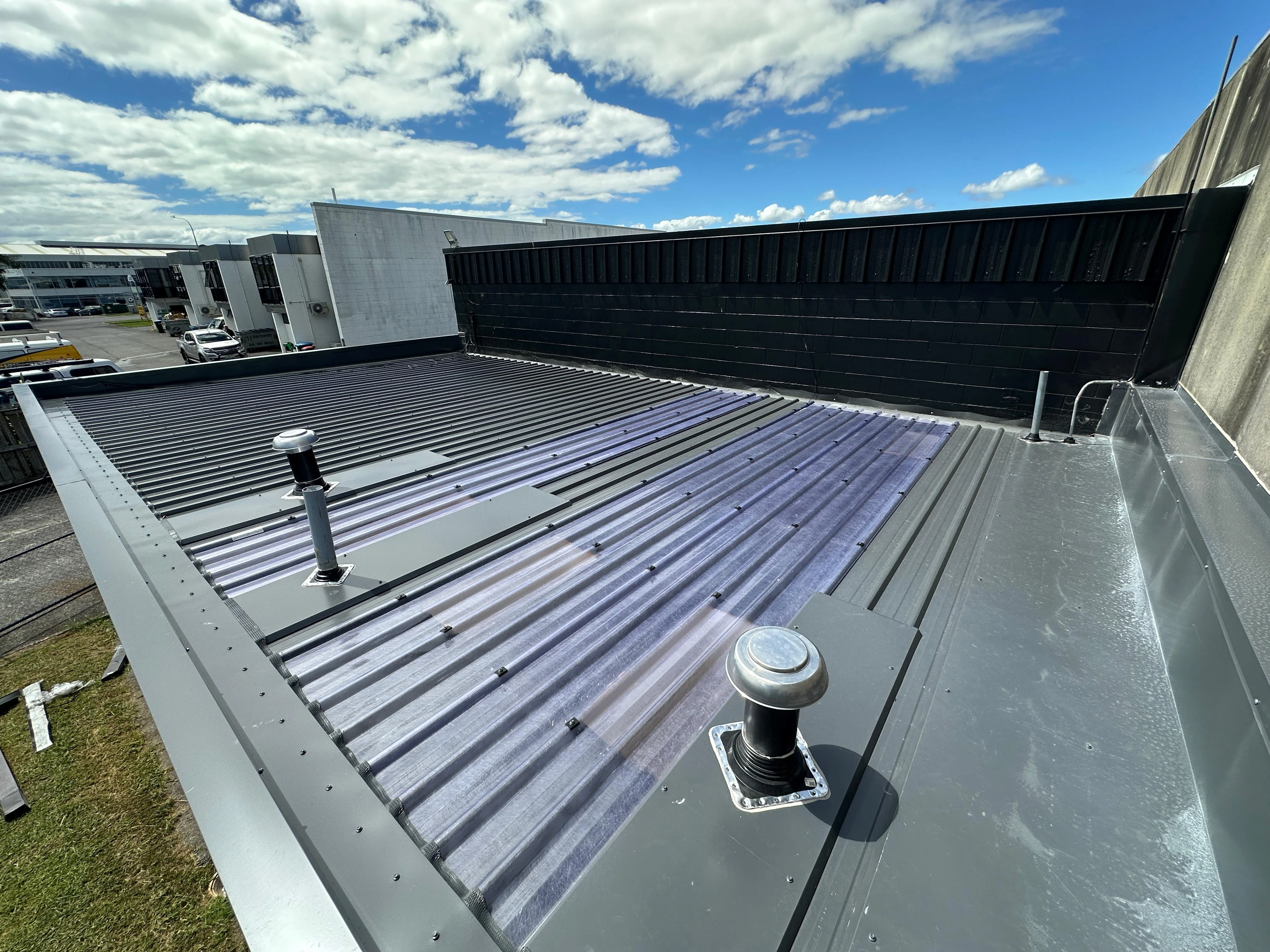 Commercial metal roof with vents and flashing