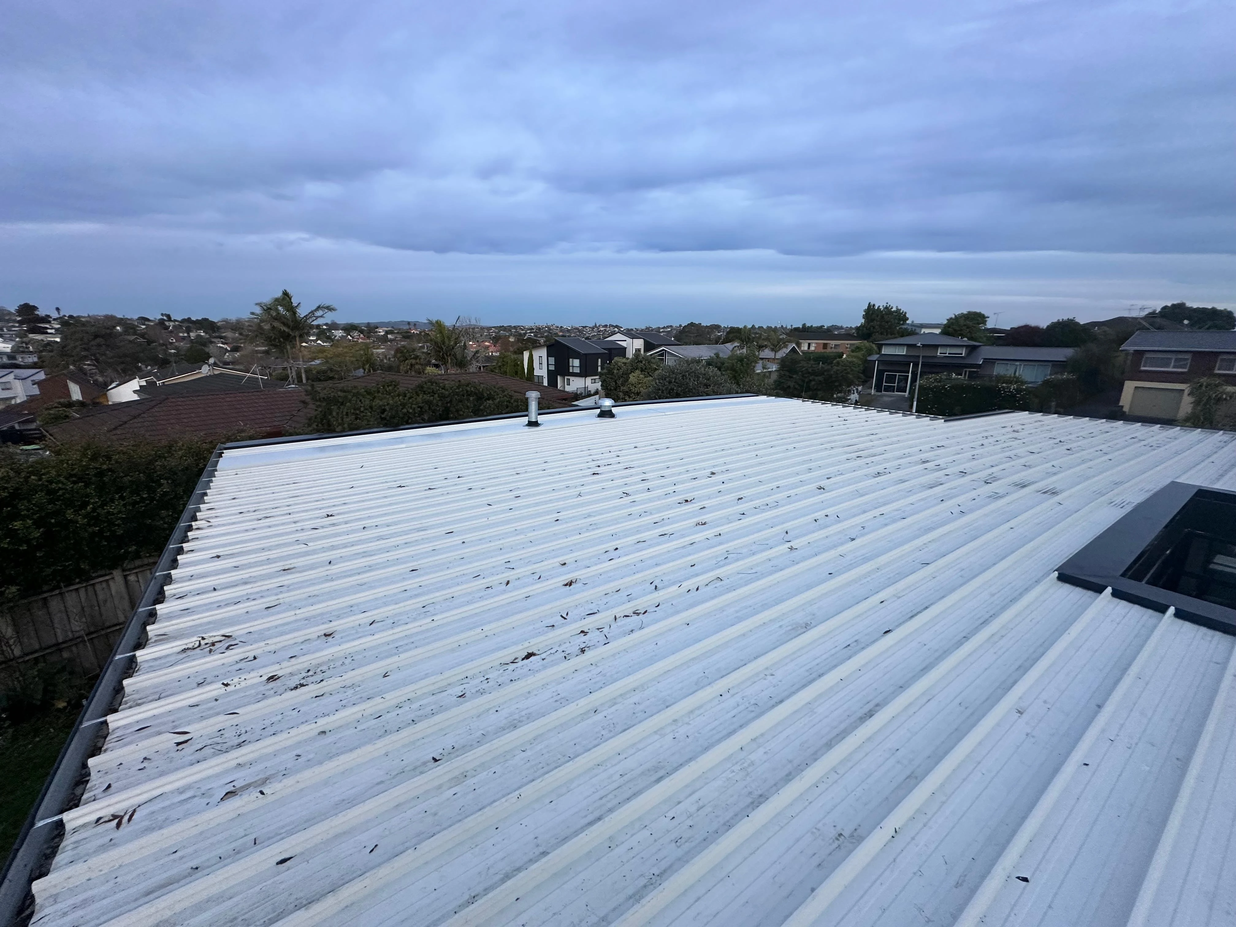 White metal roof overlooking Auckland at sunset