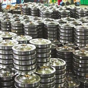 Stacked railway wheels in warehouse