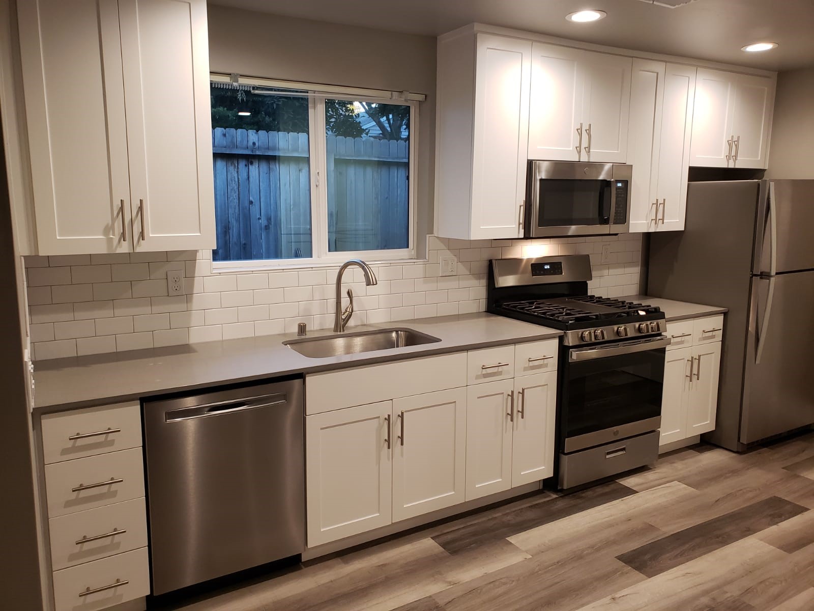 White Shaker — New cabinets, gray quartz tops