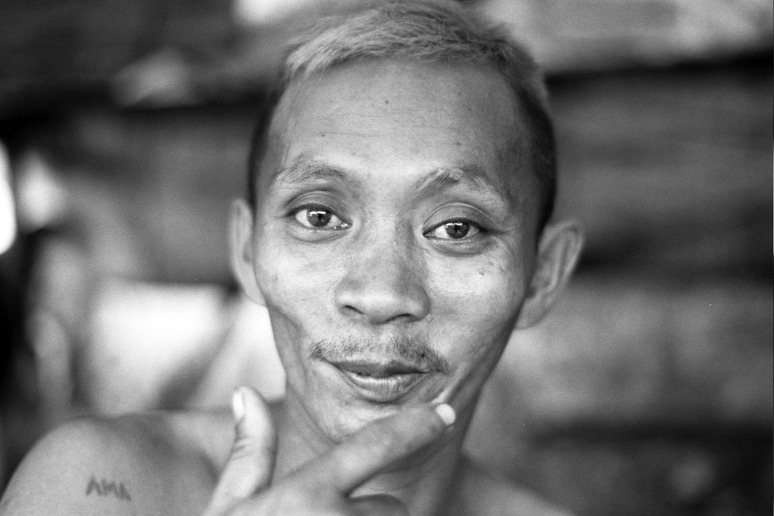 Close-up portrait of middle-aged Filipino man with engaging direct gaze looking at camera