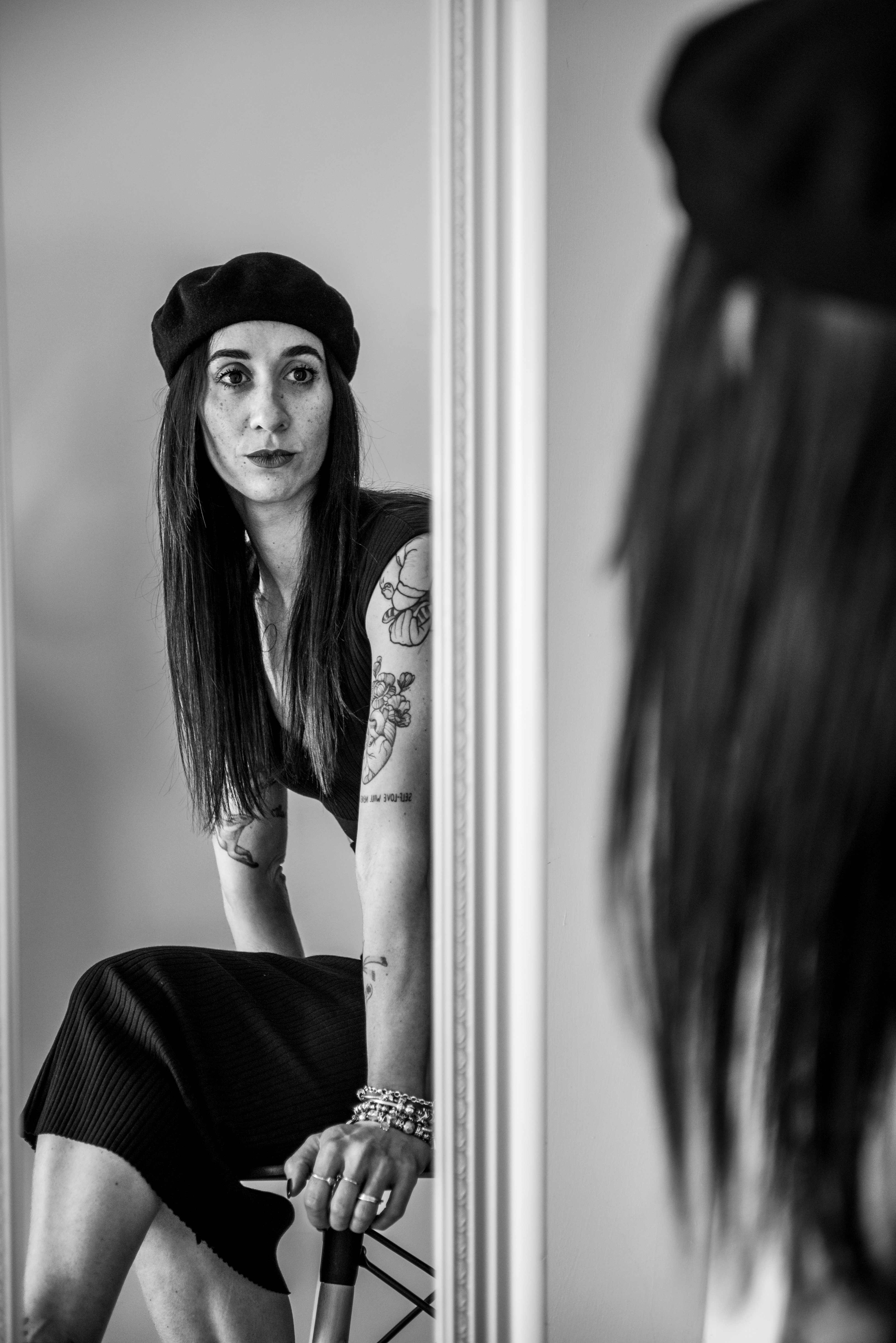 Woman with beret looking in mirror