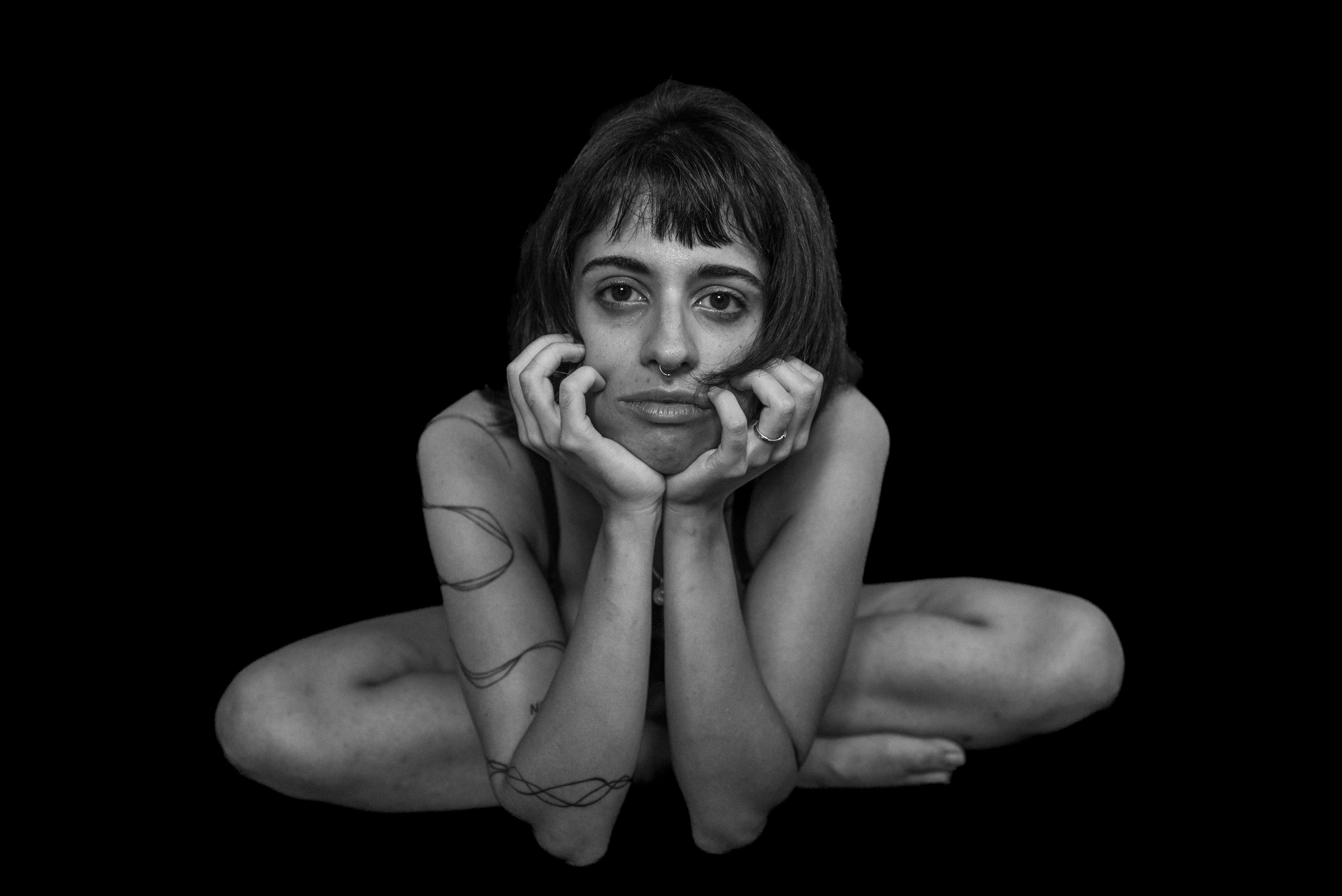 Woman with bangs hands under chin