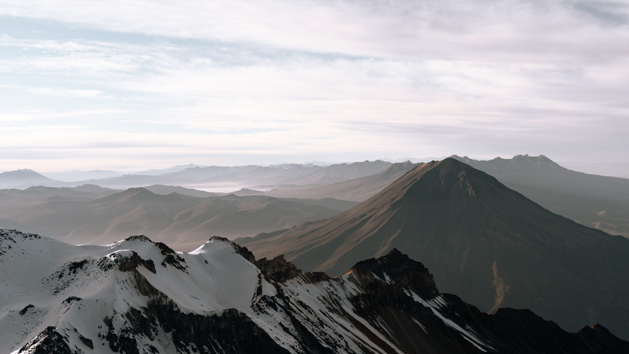 Snow-capped mountain ridges with volcanic peak