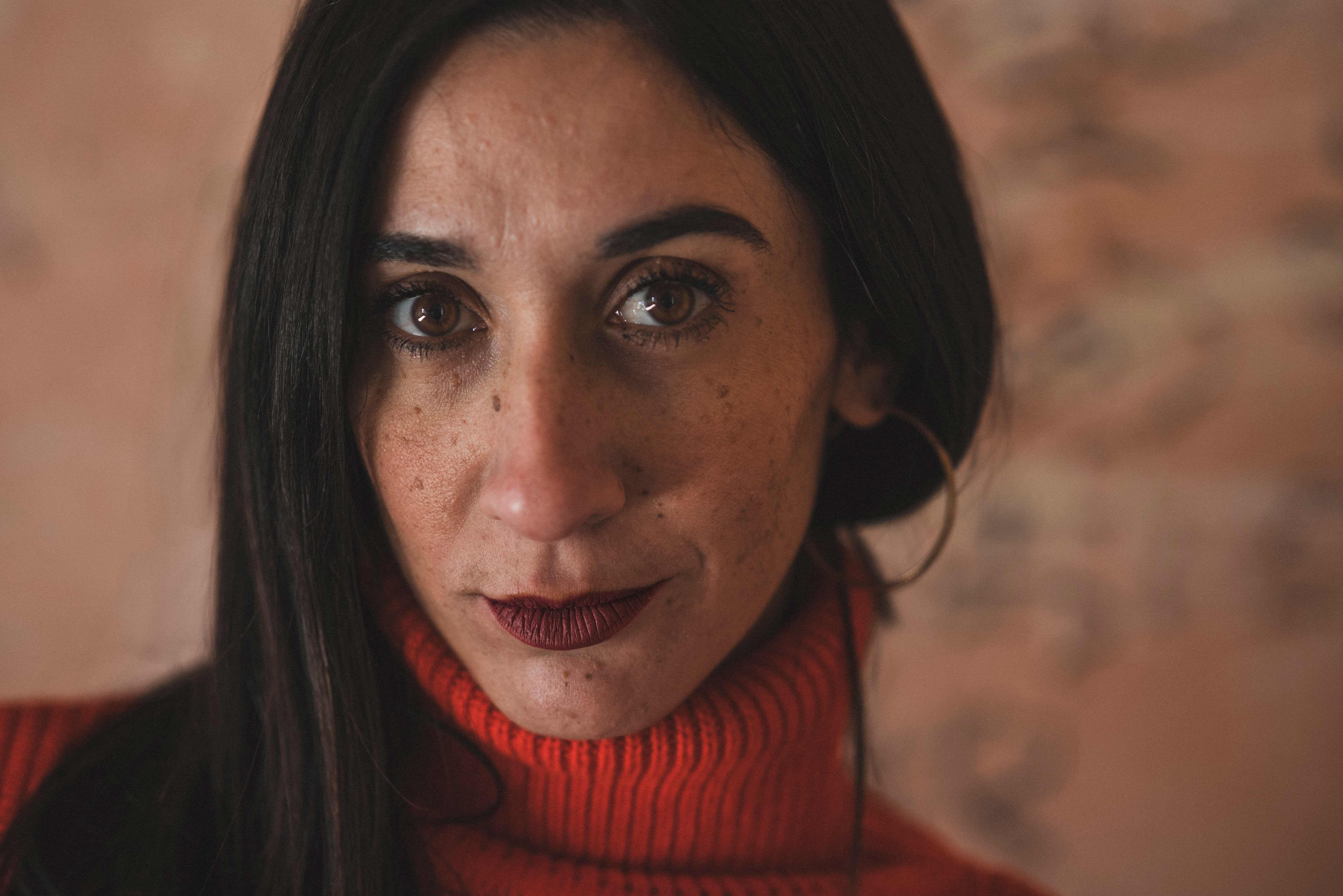 Close-up portrait of woman in red turtleneck