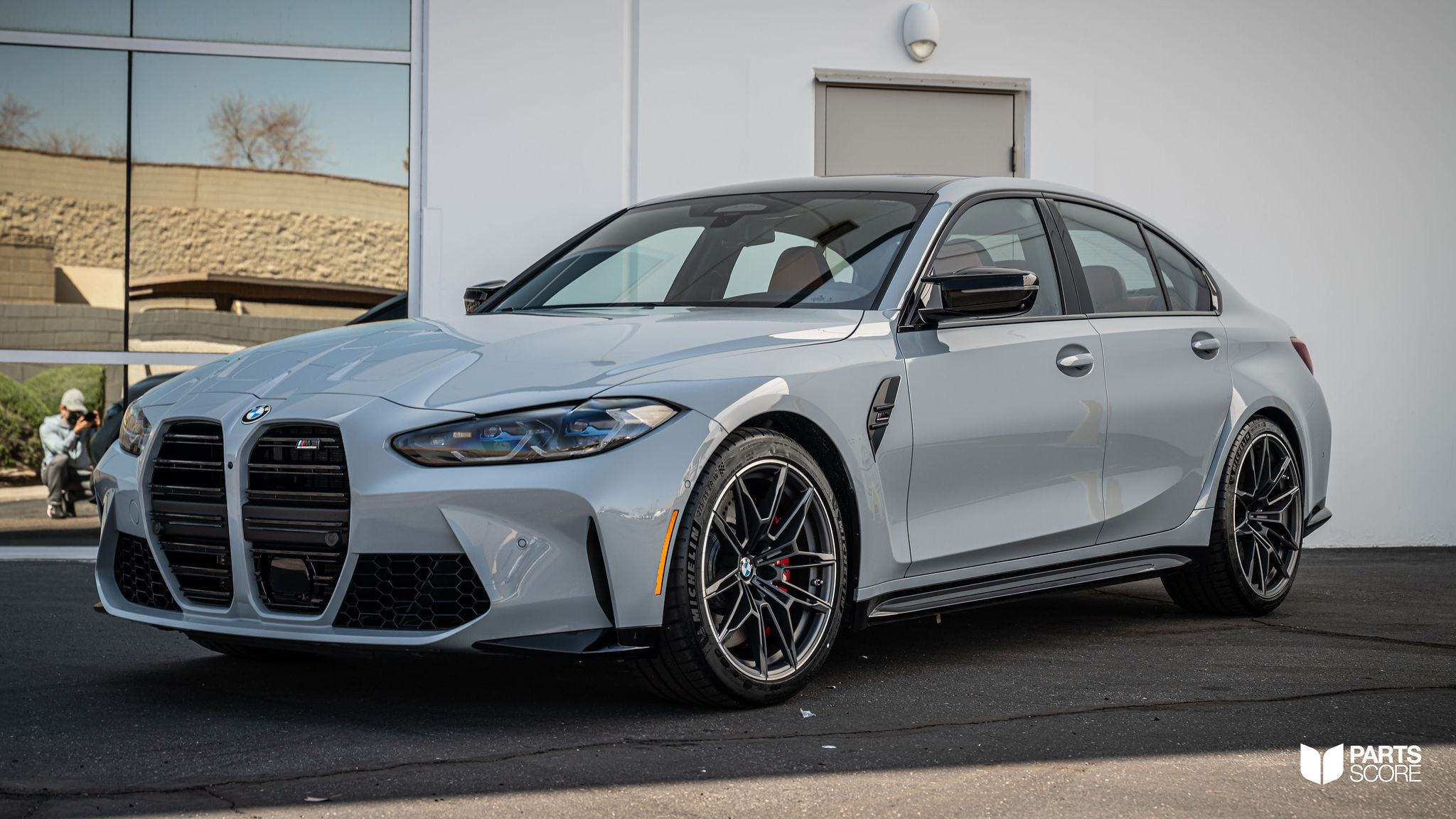 BMW M3 Competition in Brooklyn Grey, 3/4 front, red M brake calipers, Michelin Cup 2s