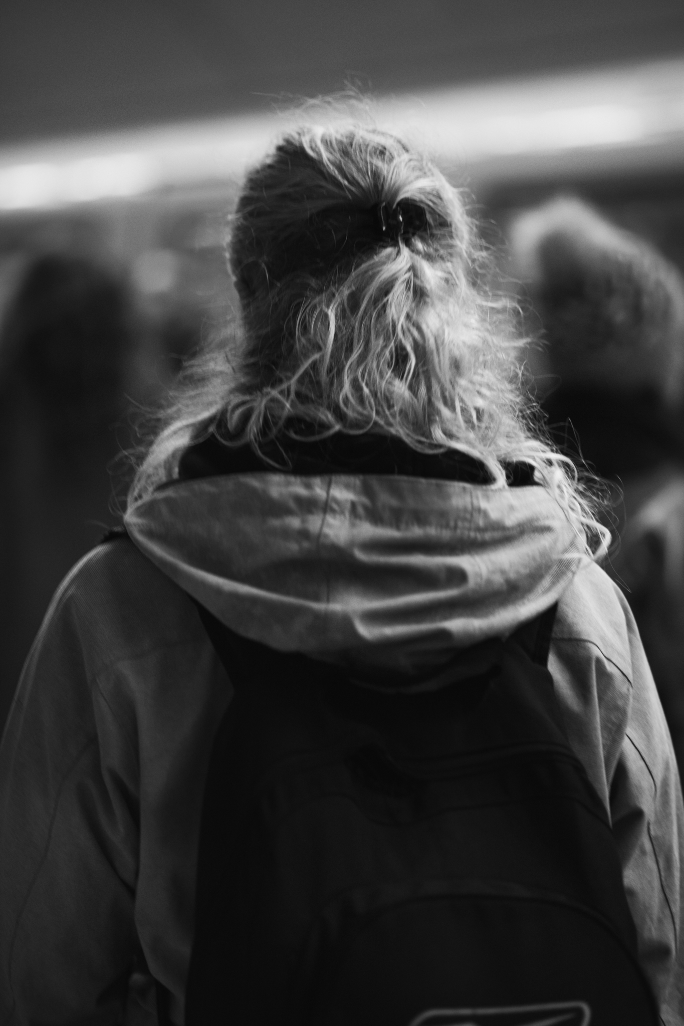 Person from behind with curly hair in jacket