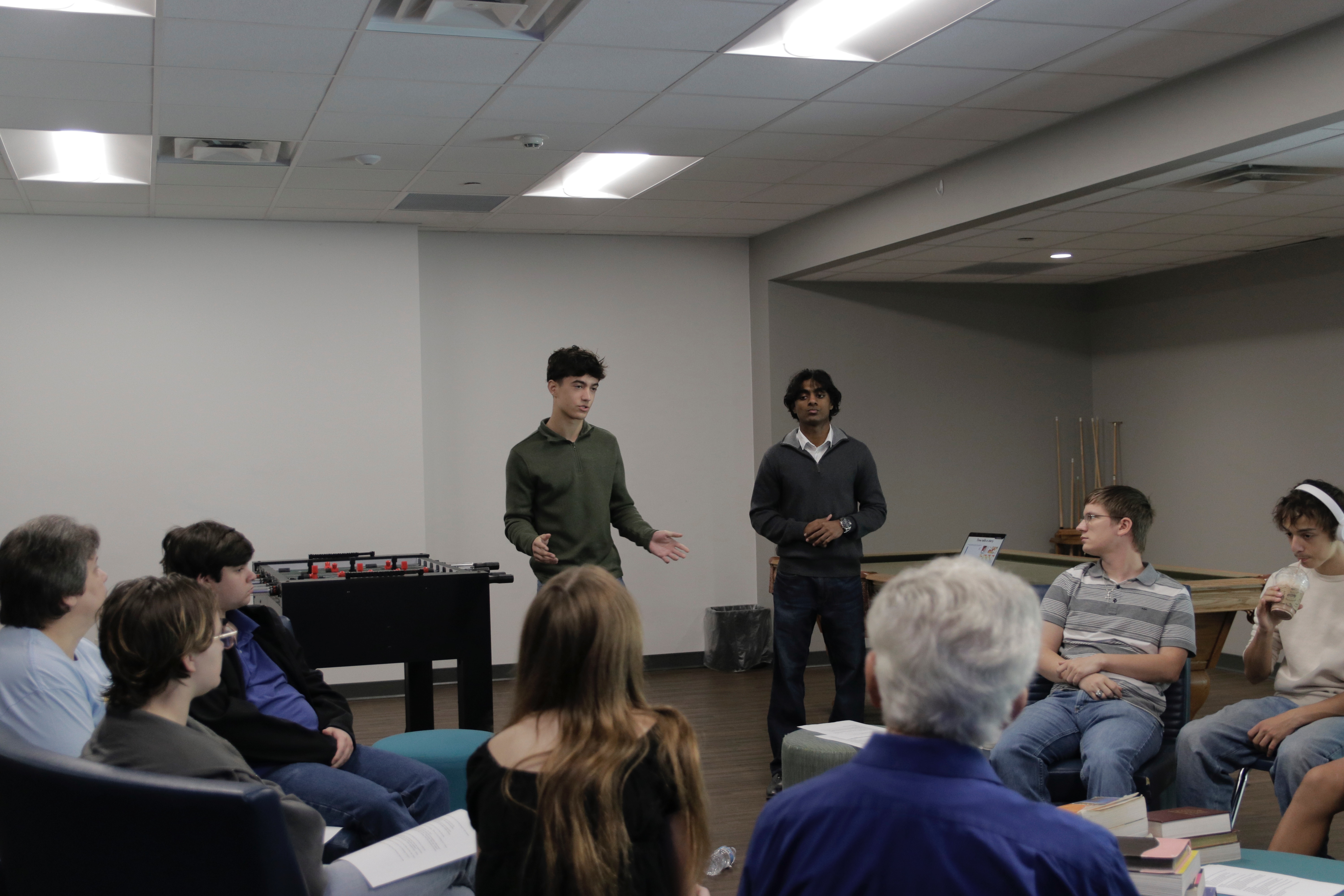 Nick Glover and Nick Joseph speaking to a small group in a community room