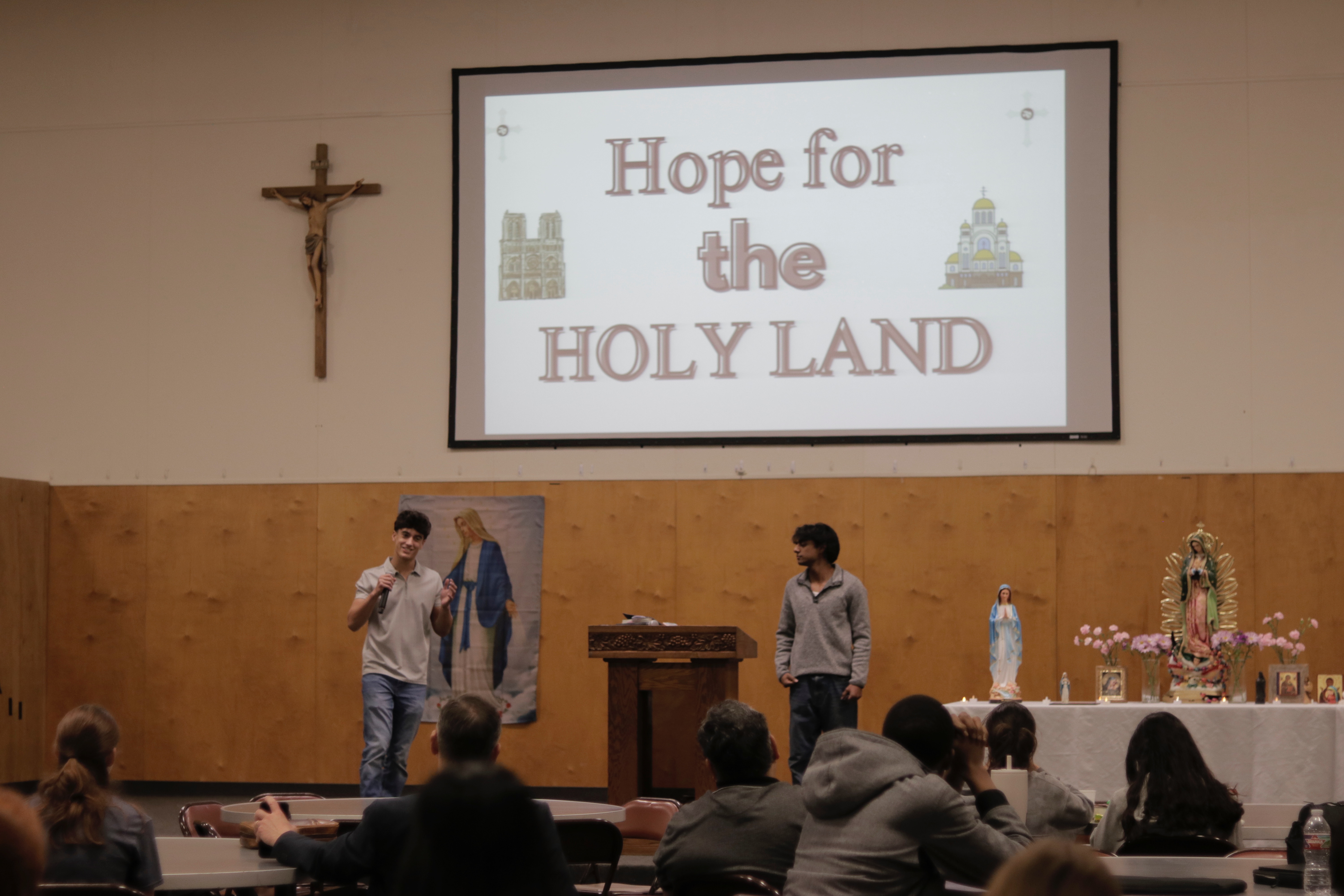 The founders presenting the Hope for the Holy Land title slide to a parish audience