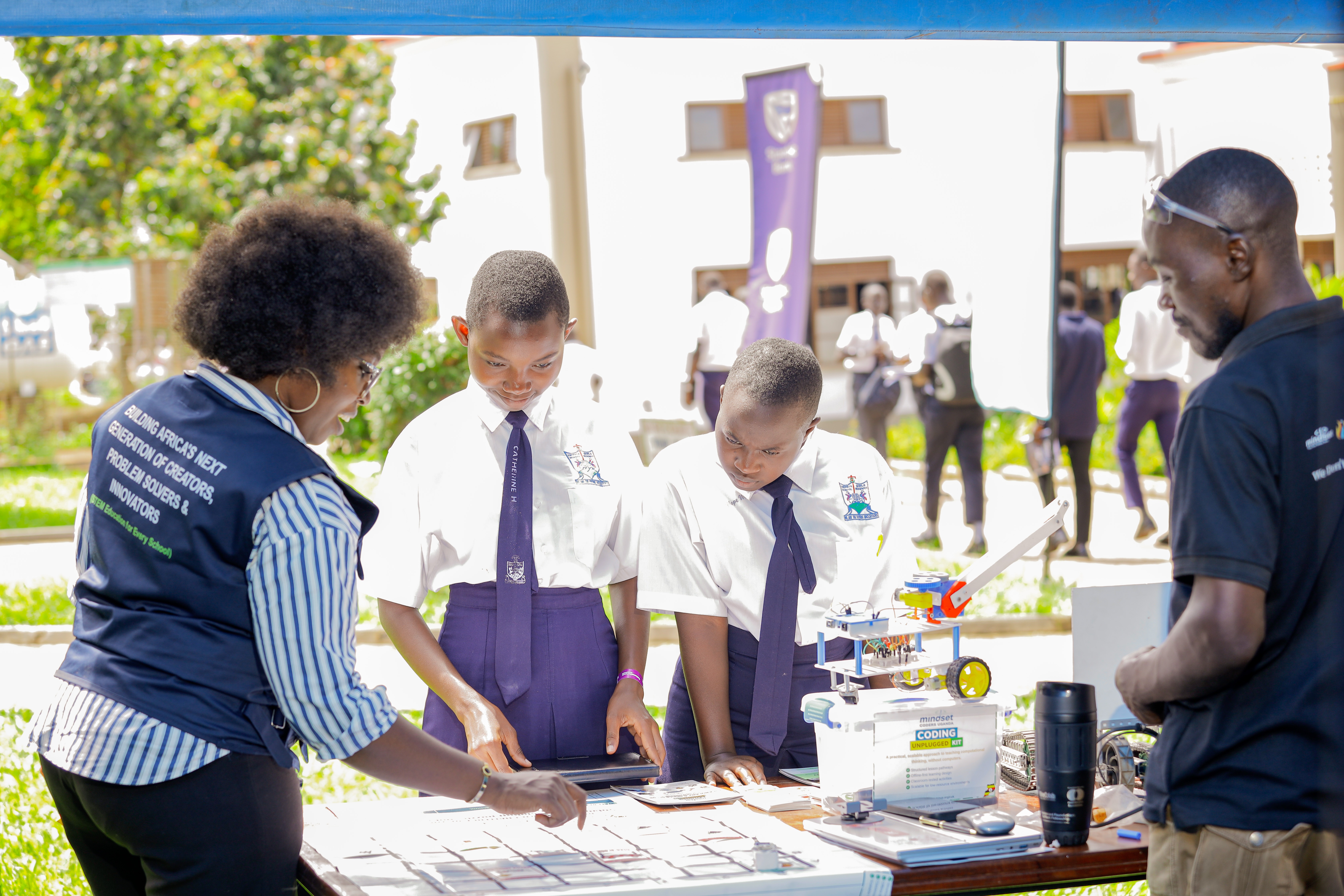 Teacher demonstrating Coding Unplugged activities to students at outdoor school session