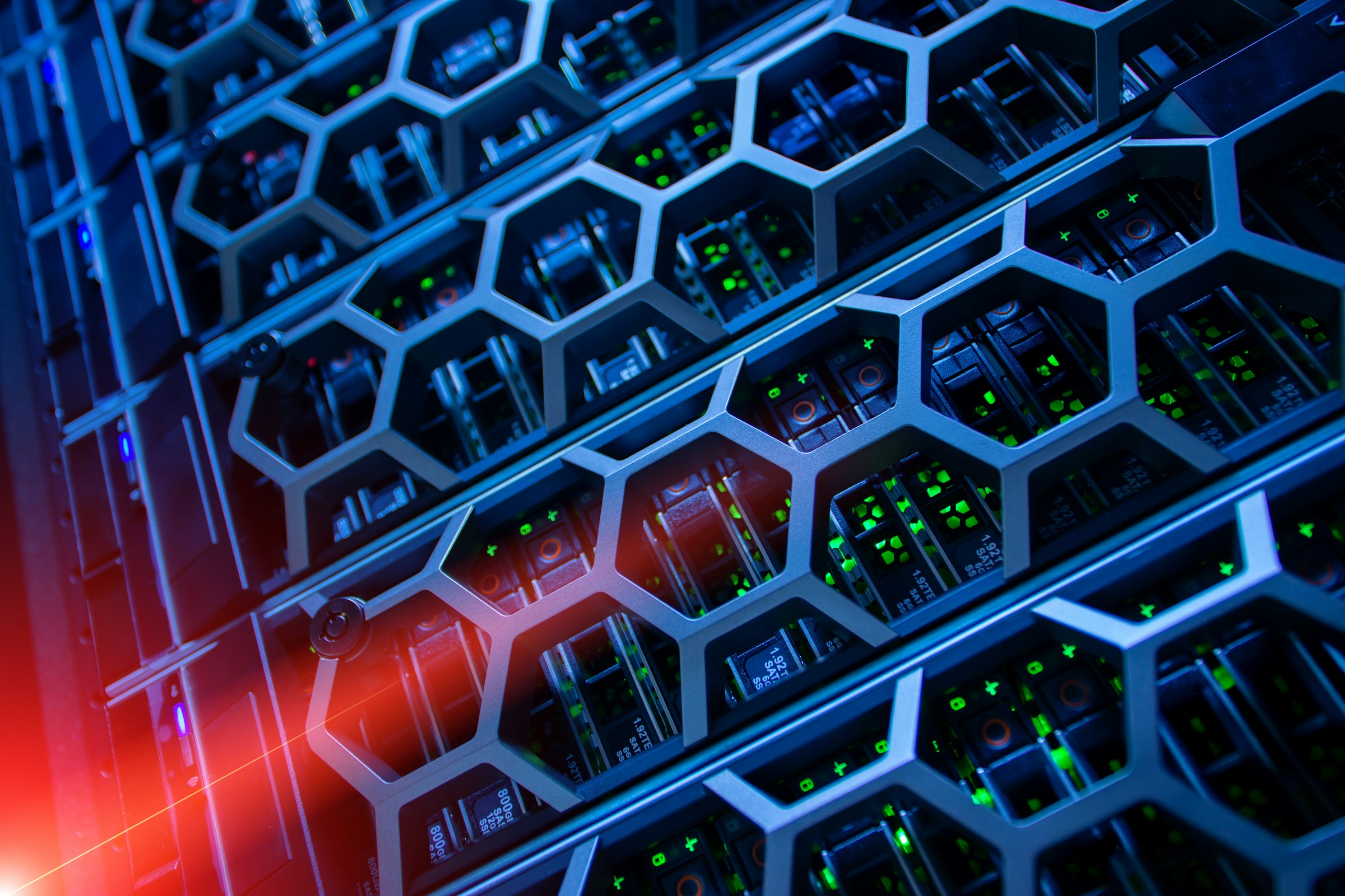Server rack hardware with hexagonal cooling grilles and blue-red lighting