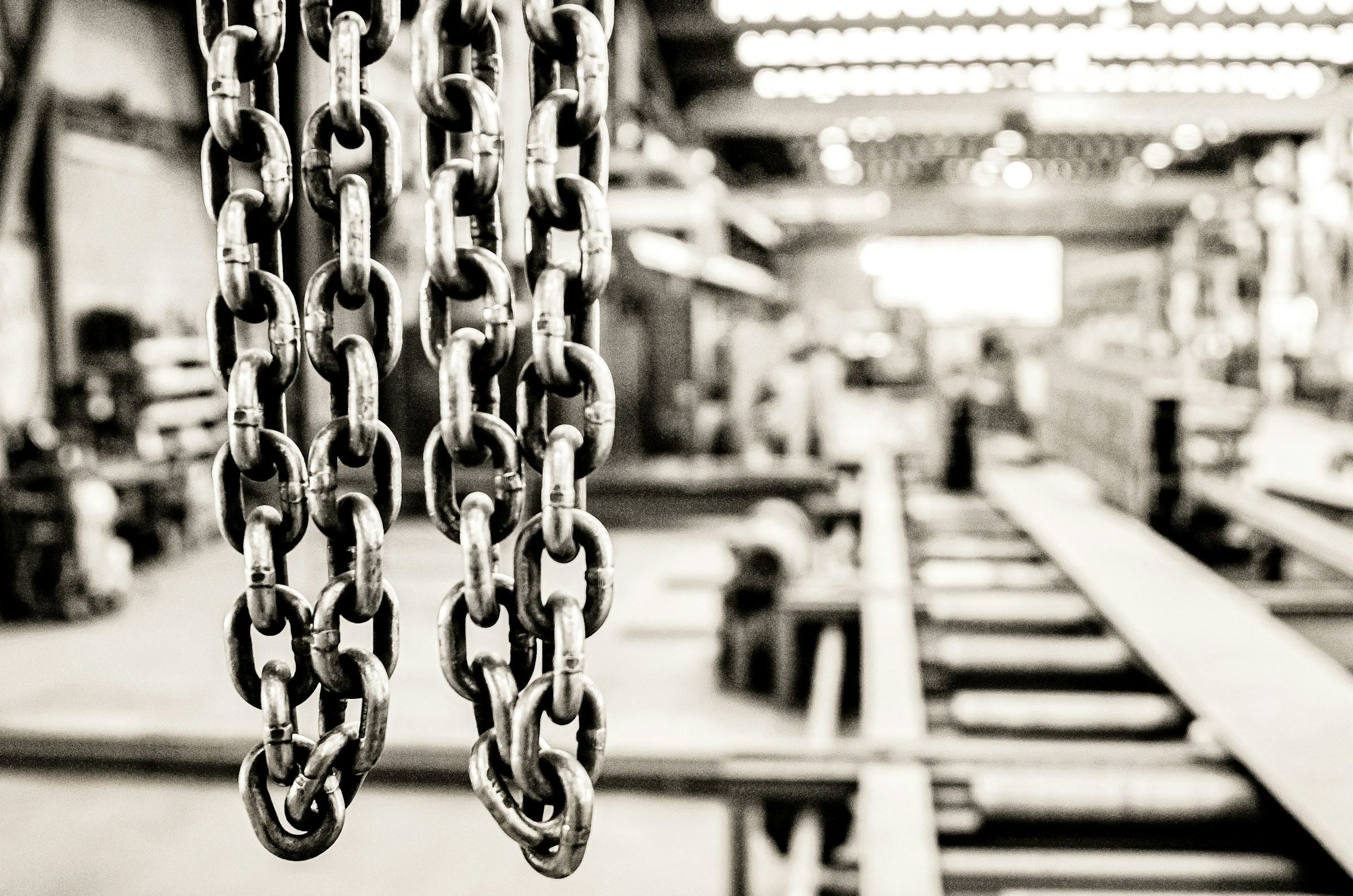 Industrial chains hanging in factory warehouse setting
