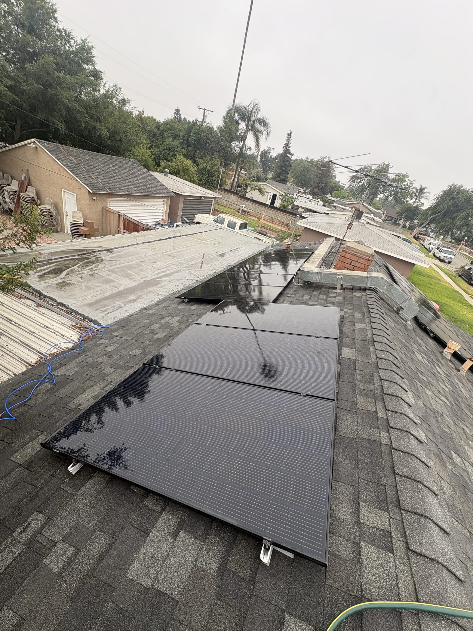 Solar panel cleaning with water spray visible