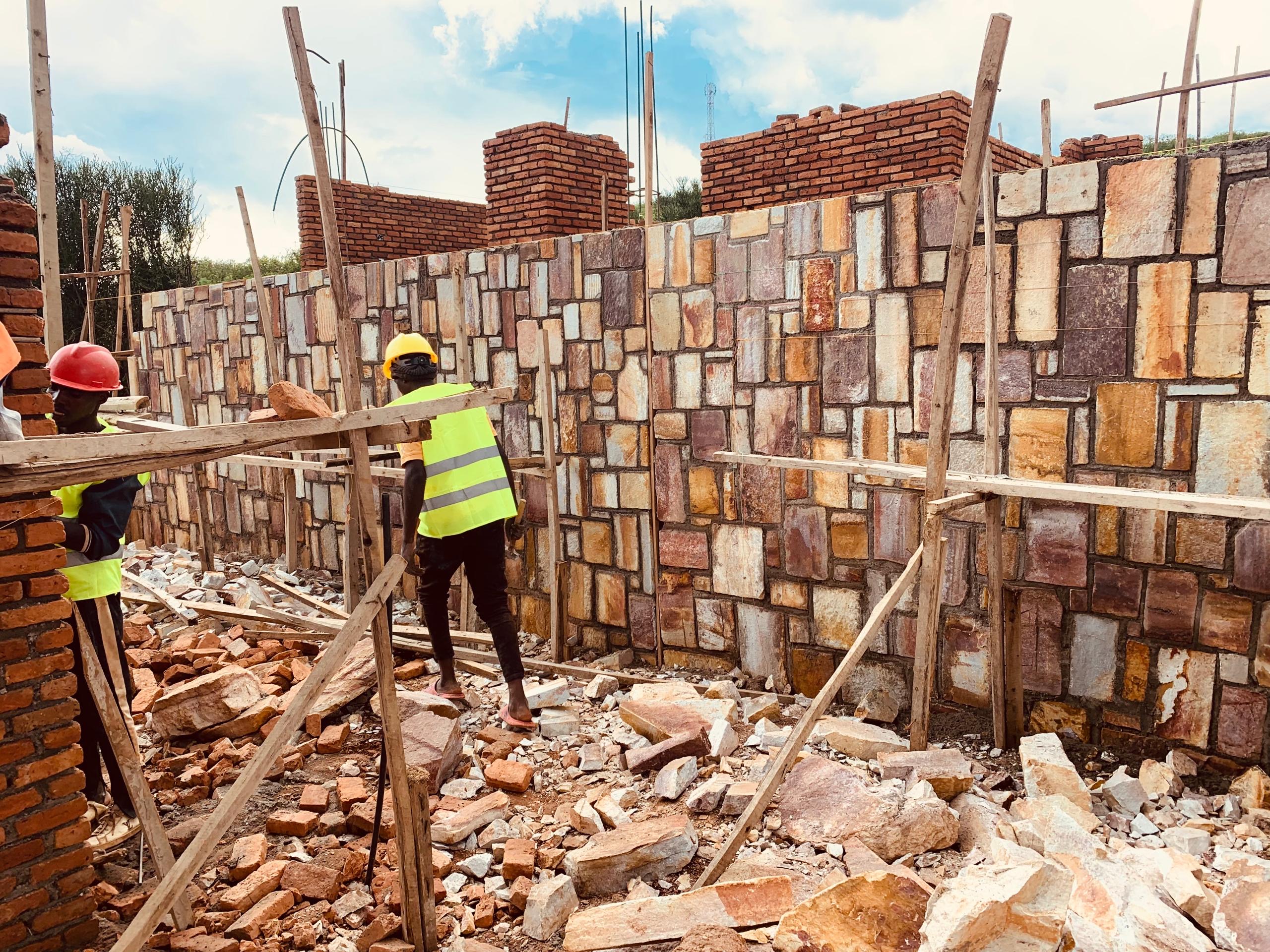 Construction team building a masonry wall