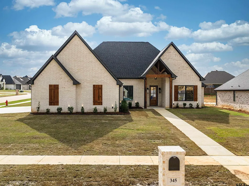 French country farmhouse with wood shutters and timber gable