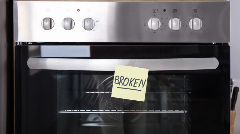 Broken oven with a sticky note