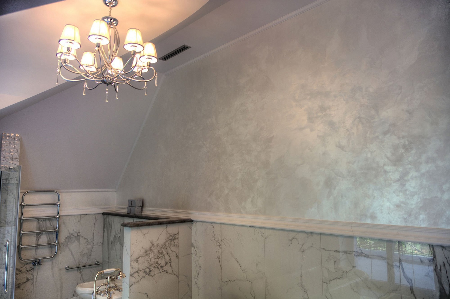Venetian plaster bathroom with chandelier and marble wainscoting