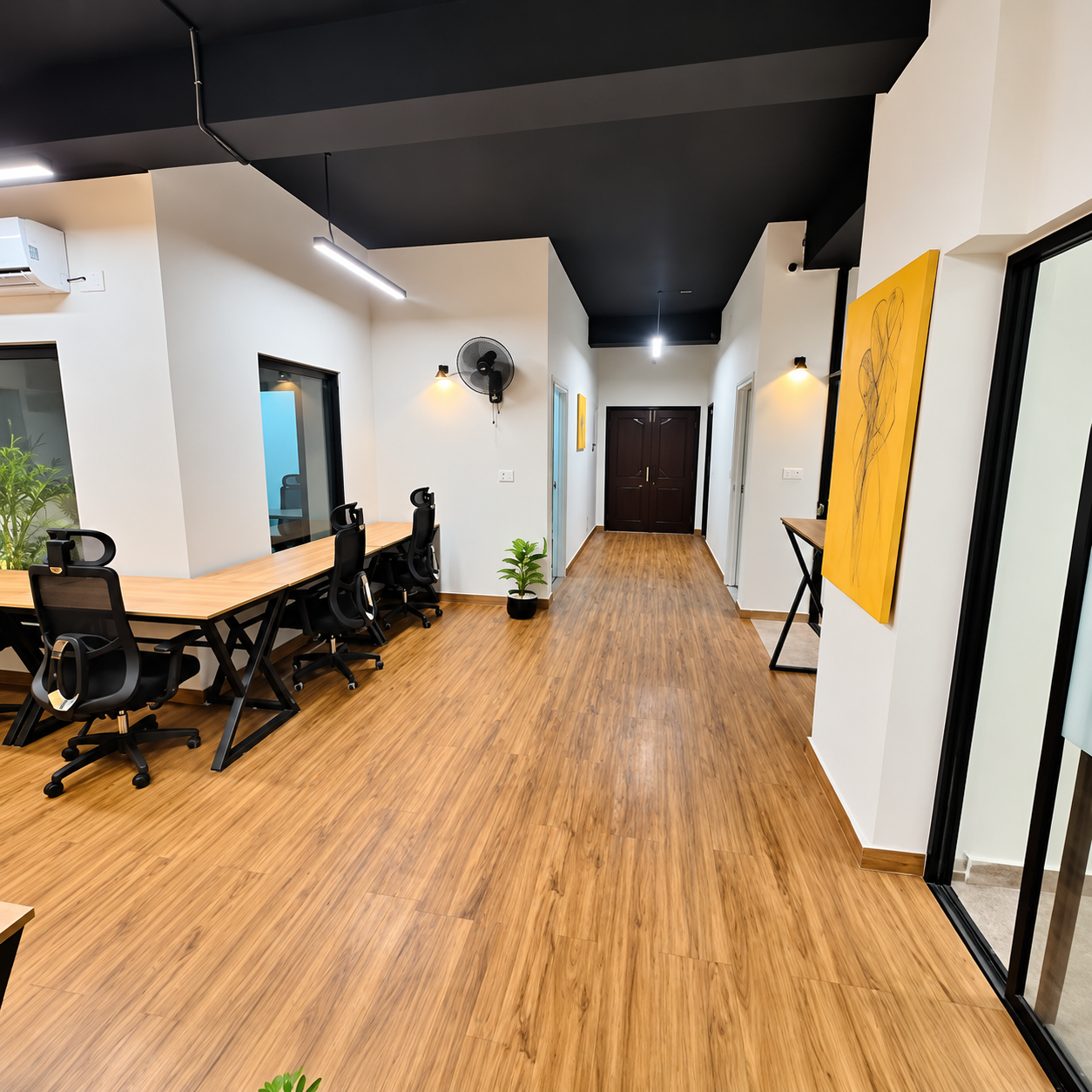 Shared office space at Panda Works Lahore with wooden flooring and open desks