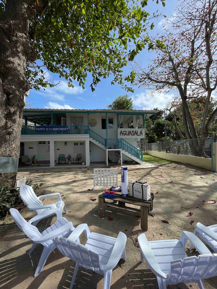 Outdoor seating area with white chairs and games in front of Aguasalá