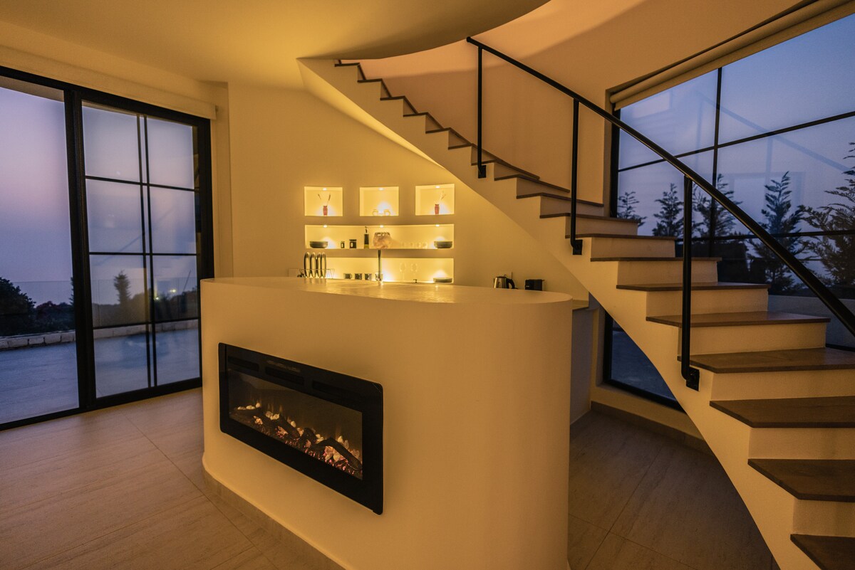 Kitchen with curved staircase and fireplace