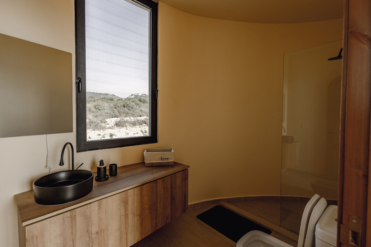 Curved bathroom with wooden vanity
