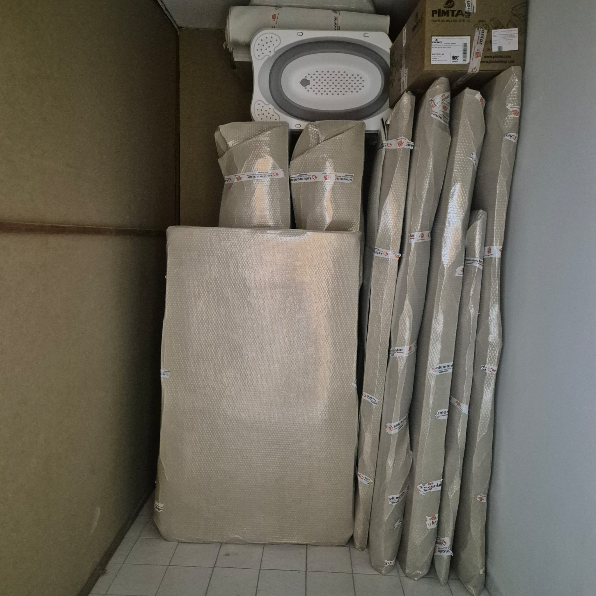 Mobilyaların koruyucu malzemelerle özenle ambalajlandığı eşya depolama odası