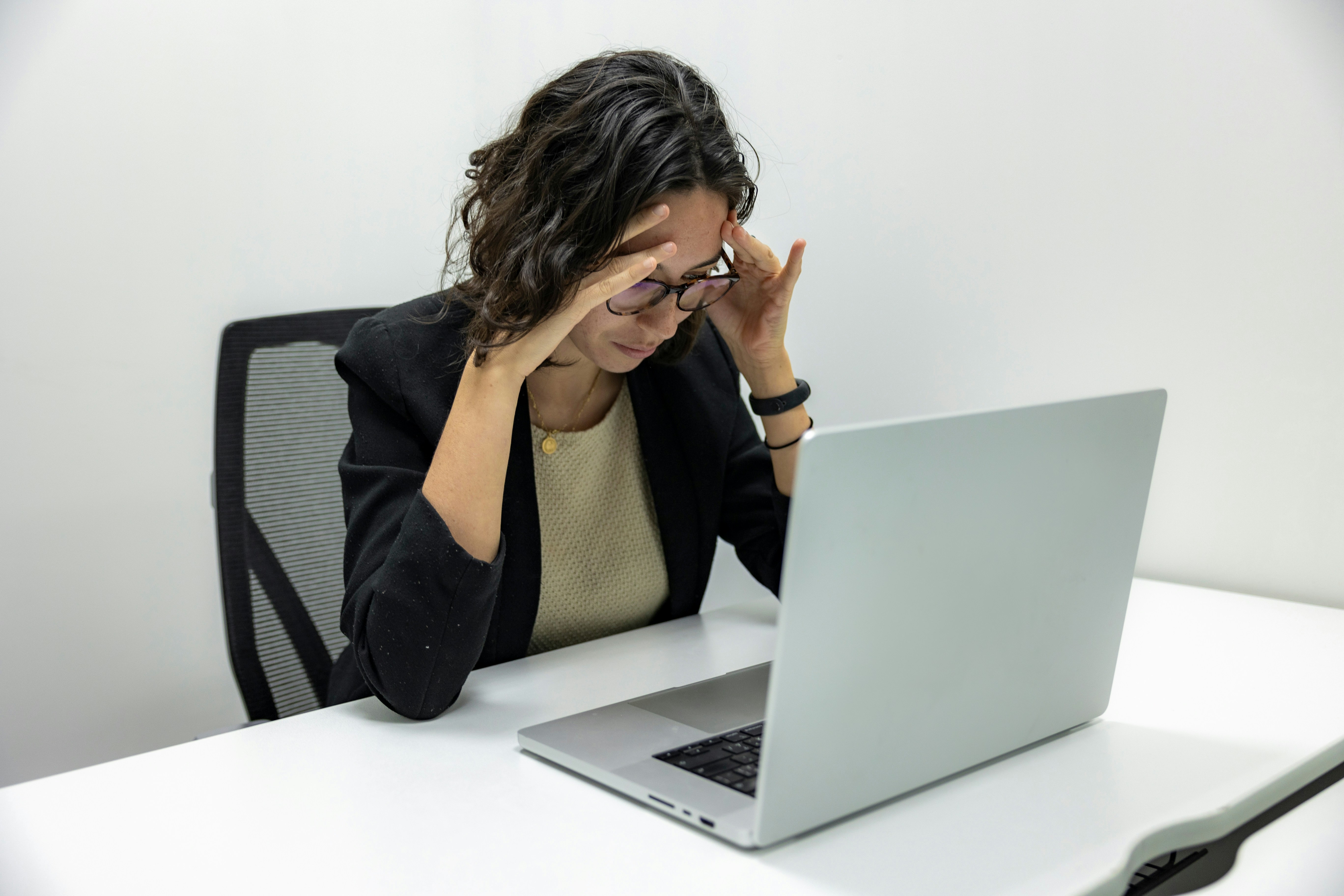 Woman experiencing digital eye strain while working on a laptop