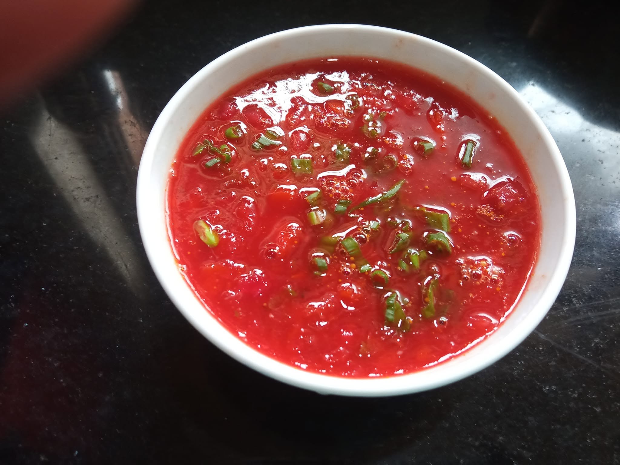 Bowl of fresh tomato chutney with green chillies