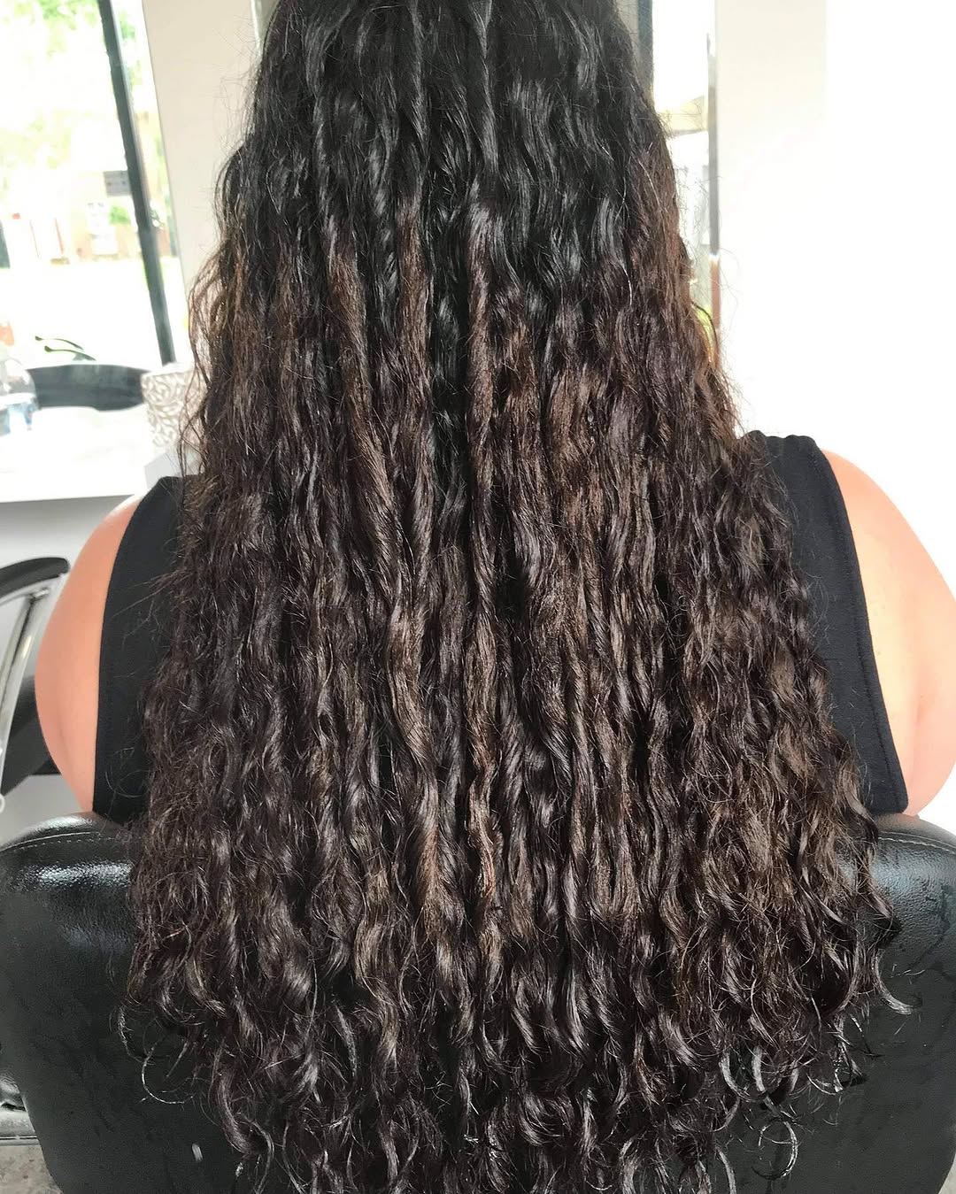 Long defined curly hair — curly hair specialist services at NAIDAS HAIRSALON