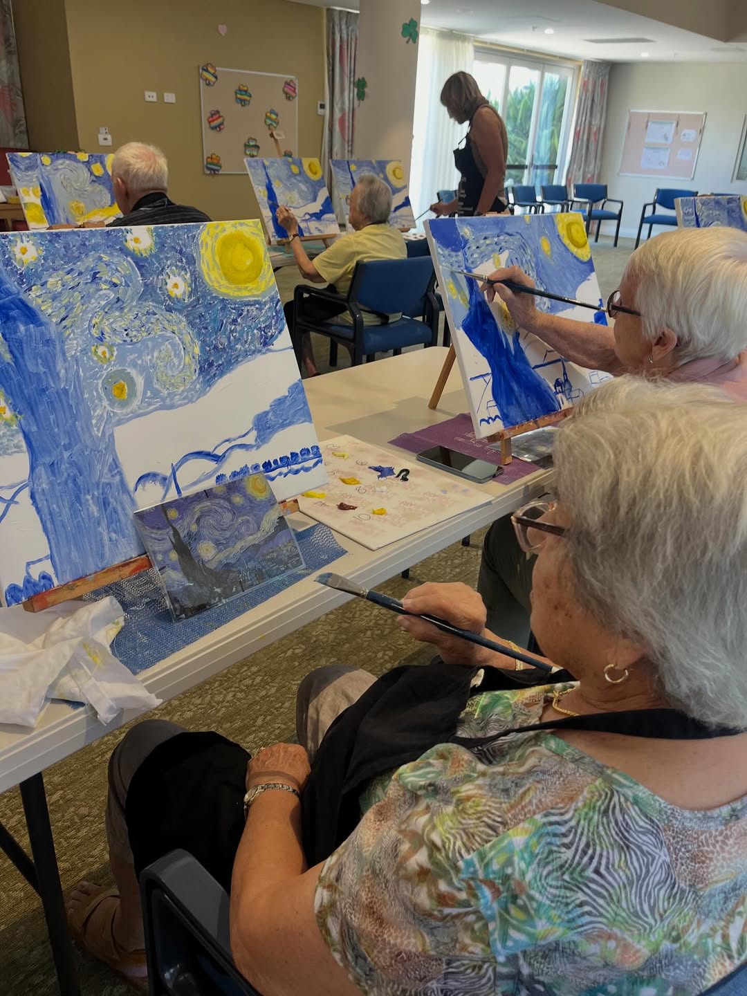 Participants setting up canvases at a community art workshop