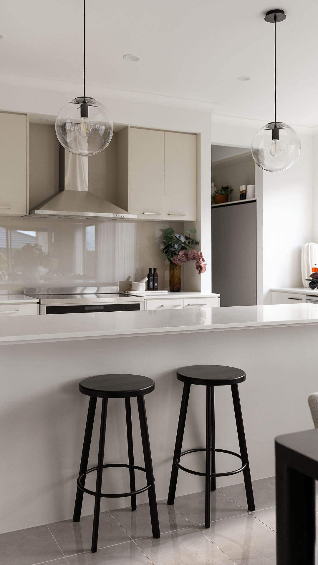 Kitchen breakfast bar with pendant lighting and bar stools in a Carlisle display home