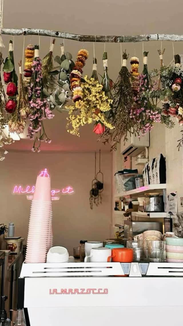 Dried flower bunches hanging above the counter at Milking It cafe