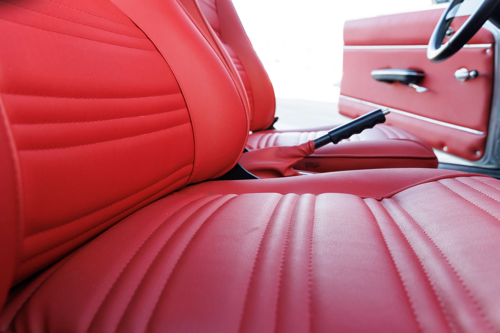 Vibrant red leather interior of a classic Alfa Romeo