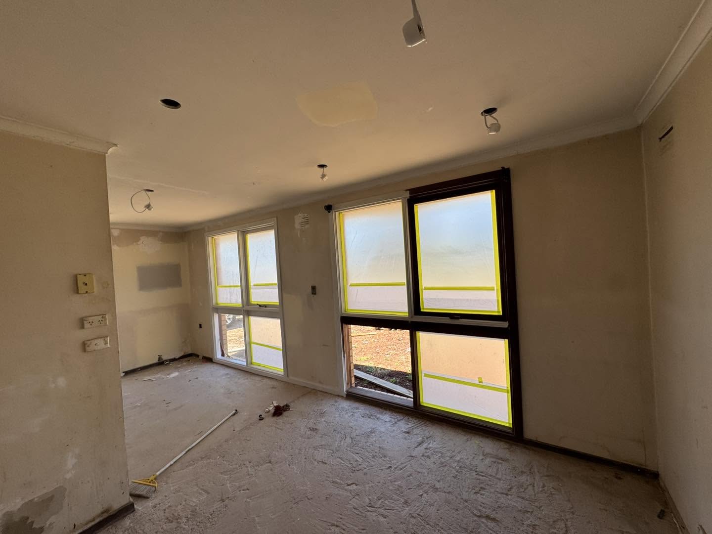 Interior room with plaster walls taped and prepared for painting